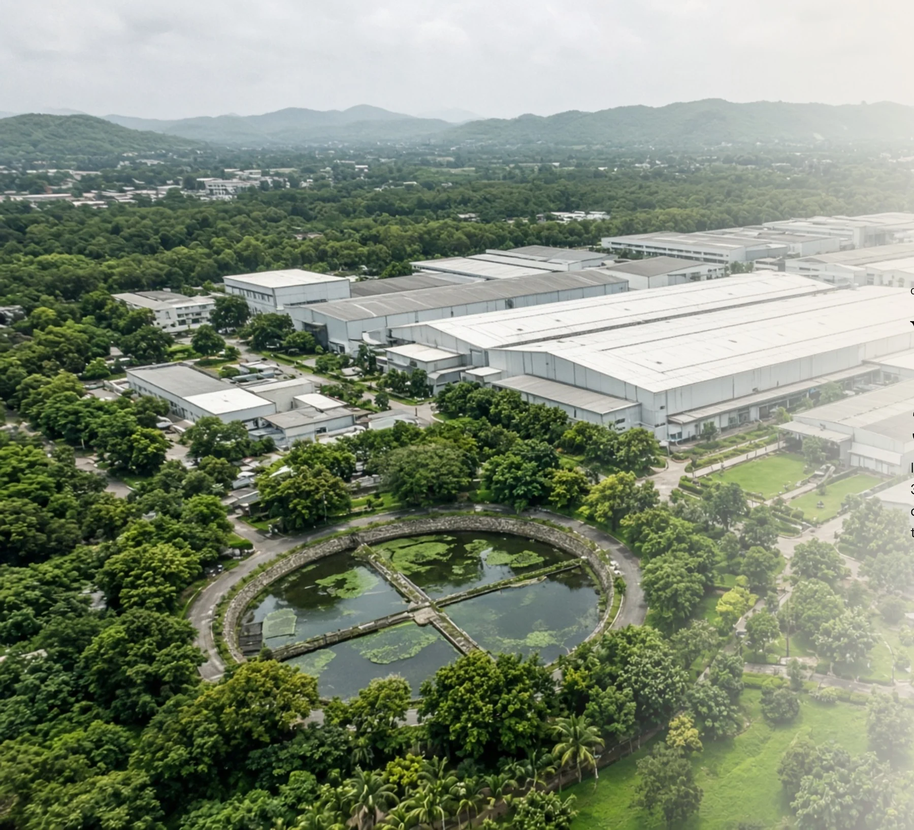 Aerial view of a manufacturing campus surrounded by greenery
